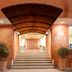 Hotel Estelar de La Feria in Bogotá entrance with canopy, steps, and potted plants