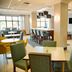 Hampton Inn & Suites by Hilton Cathedral City Palm Springs breakfast area with tables, bar seating and lounge chairs