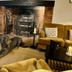 Ravenwood Hall Hotel, Bury St. Edmunds: cozy lounge with fireplace, armchairs and a large dog on the rug