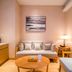 Clovelly Garden Hotel Shanghai cozy lounge with sofa, armchairs, coffee table and wall art