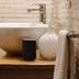 Giardino Sul Duomo in Ragusa bathroom vanity with vessel sink, towel rack, and neutral tile wall