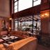 Vitina House in Vytina: cozy lounge with fireplace, sectional sofa and large windows overlooking terrace
