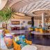 Time Coral Nuweiba Resort lobby with colorful seating, patterned ceiling, and potted palms in Nuweiba