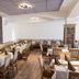Hotel Landgasthof Hohenauer Hof restaurant dining room in Hohenau with set tables and stone accent wall