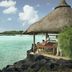 Paradise Cove Boutique Hotel in Cap Malheureux with thatched seaside cabana over turquoise water