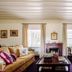 Quinta Nova Winery House - Relais & Châteaux living room with fireplace, sofa, coffee table and windows in Covas do Douro