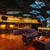 Mandarin Oriental, Kuala Lumpur lounge with modern seating, glowing bar, and dramatic ceiling lighting
