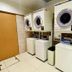 Toyoko Inn Higashi hiroshima Ekimae laundry room with stacked washers and dryers in Higashihiroshima