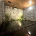 Hotel Route Inn Hakata Ekimae in Fukuoka: indoor hot spring bath with stone wall and reflective water