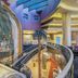 Limak Eurasia Luxury Hotel in Istanbul atrium with palm trees, curved staircase and ornate railings