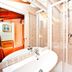 Art Palace - Residenza Giardini Venice bathroom with bathtub, shower and pink tiled walls