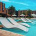 Sheraton Pilar Hotel & Convention Center in Pilar: modern pool with white loungers and palm trees