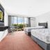 Hope Harbour Hotel in Hope Island guest room with two beds, balcony doors and marina view