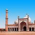 Amrit Villa, New Delhi: historic mosque-style facade with domes and tall minarets under a clear blue sky