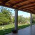 Domo Minnannu Miriu in Loiri Porto San Paolo, covered patio overlooking a green garden