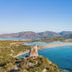 Almar Timi Ama Villasimius overlooking a turquoise bay, beach, and coastal mountains in Villasimius