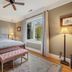 Chateau de Vie Calistoga bedroom with king bed, bench, lamps, and window view
