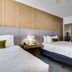 Homewood Suites by Hilton Louisville-East guest room with two beds and bathroom doorway in Louisville
