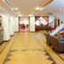 Hotel Estelar de La Feria Bogotá lobby with reception desk, seating area and staircase