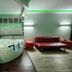 Motel 6 Little Rock North spa room with whirlpool tub, red sofa, and green accent lighting in North Little Rock