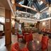 Hotel du Vin Brighton in Brighton lobby lounge with brick walls, high ceiling, bar, and red velvet chairs