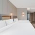 Motel Shanghai Liuzhou Road Guangda Convention And Exhibition Centre room with twin beds and seating area in Shanghai