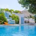 Hotel Maria de Lourdes in Cancún with outdoor pool and tropical waterfall feature