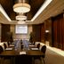 Arjaan by Rotana Dubai Media City meeting room with long conference table and projector screen