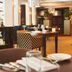 Parkhotel Tjaarda in Oranjewoud restaurant interior with tables, chairs, and elegant lighting