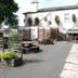 The Railway Inn in Brixham, outdoor patio with picnic tables and flower baskets beside the hotel