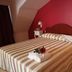 Palace Hotel Una Nuova Strada room in Nocera Terinese with striped bedspread and red walls