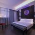 Orange Hotel Beijing Tianning Temple guest room with king bed and purple accent lighting in Beijing