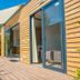 Concept Village Piccola Gardiola in San Felice del Benaco, wooden terrace with sliding glass doors and shaded patio