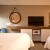 Hampton Inn Pennsville room with two beds, wall-mounted TV, microwave, and framed bridge art
