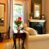 Mccall House Boutique Inn Ashland sitting room with fireplace, sofa, armchair and tall windows