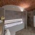 Sunstar Hotel Piemont in Asti bathroom with freestanding tub, double sink vanity and brick arched ceiling