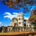 Hiroshima Ekimae Green Hotel in Hiroshima, historic concrete building with autumn trees