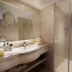 Grand Metropark Hotel Hangzhou bathroom with vanity sink, mirror, and glass shower in Hangzhou