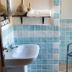 Domo Minnannu Miriu bathroom in Loiri Porto San Paolo with sink, tiled walls and chair