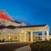 Hilton Garden Inn Auburn exterior at dusk with illuminated entrance and covered porte cochere