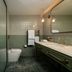 Milton Park Country House Hotel & Spa bathroom in Bowral with glass shower, toilet and green vanity