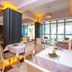 New Hotel Kuc by Marvel in Sveti Stefan dining room with set tables and warm orange lighting