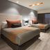 Real Inn Perinorte in Tlalnepantla guest room with two beds, desk, chair and wall-mounted TV