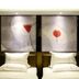 Dunhe Apartment Guangzhou twin beds in a hotel room with abstract wall art