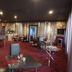 The Retreat at Froog Moore Park in Tamworth lounge with red-striped carpet, seating, and metallic curtain backdrop
