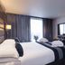 Park Grand Heathrow in Hounslow bedroom with king bed, wall-mounted TV, and large window with curtains