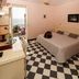 Hotel Splendid Mare in Laigueglia with guest room, black-and-white checkered floor, and balcony sea view