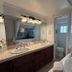 Casa Tropicana San Clemente bathroom with double vanity, soaking tub, and separate toilet room