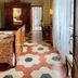 Antica Dimora Leones, Palaia: antique guest room with ornate bed, wardrobe, tiled floor and sheer curtains