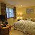 The Bay Horse Hotel And Restaurant in Ulverston bedroom with twin beds, lamps, desk and window